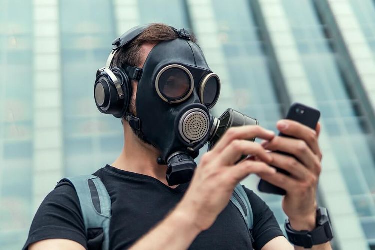 Man in Gas Mask Listening to Music